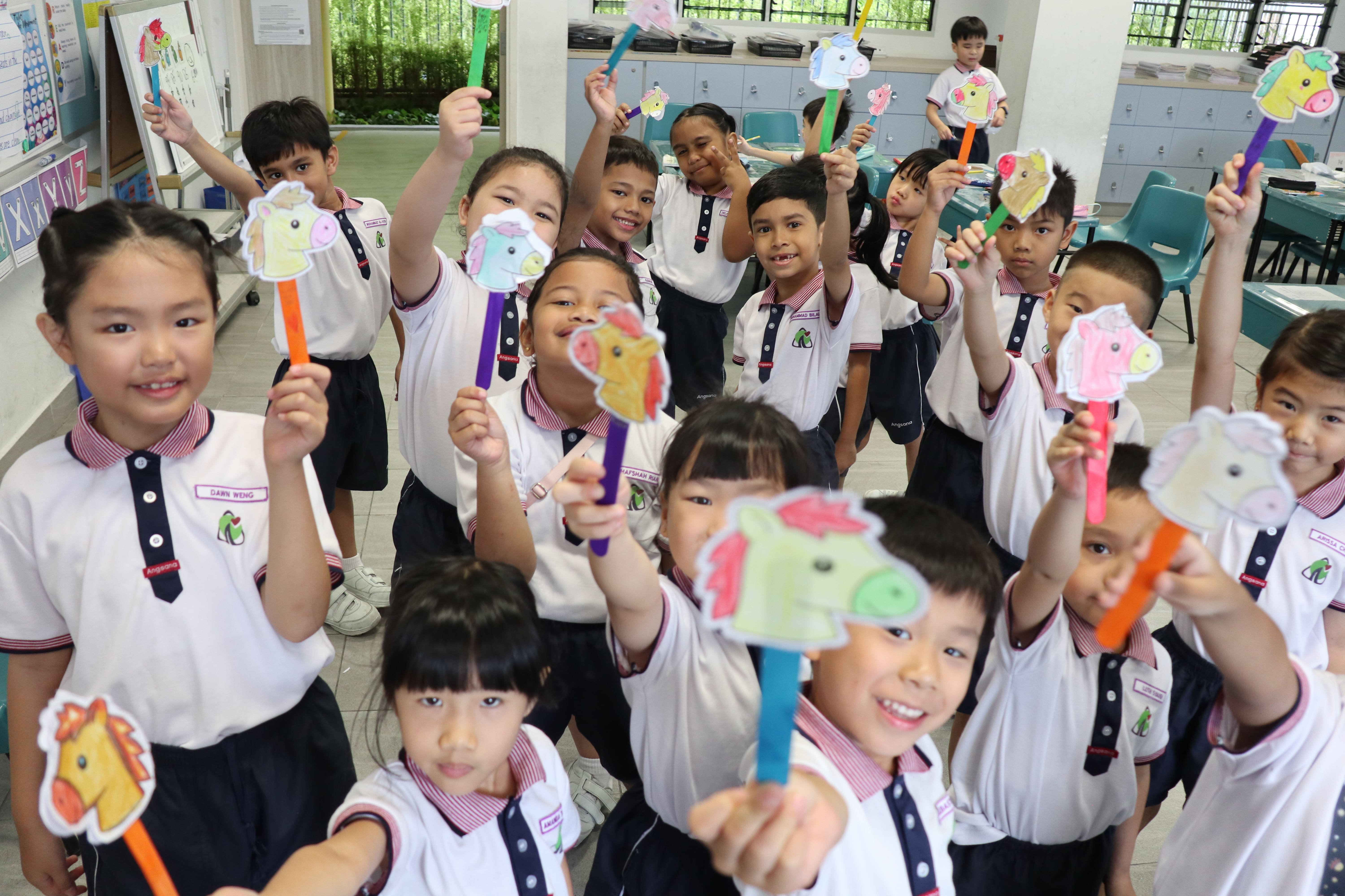 Students in the classroom doing CNY handicrafts